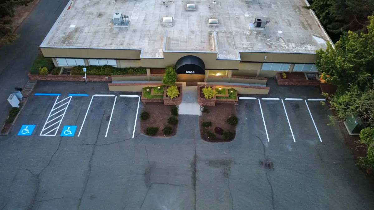 Aerial view of new ADA accessible stalls and hatched access aisle at an office building