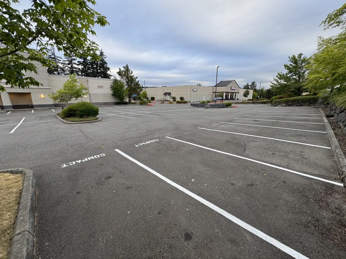 Retail lot with fresh compact-stall striping after a restripe