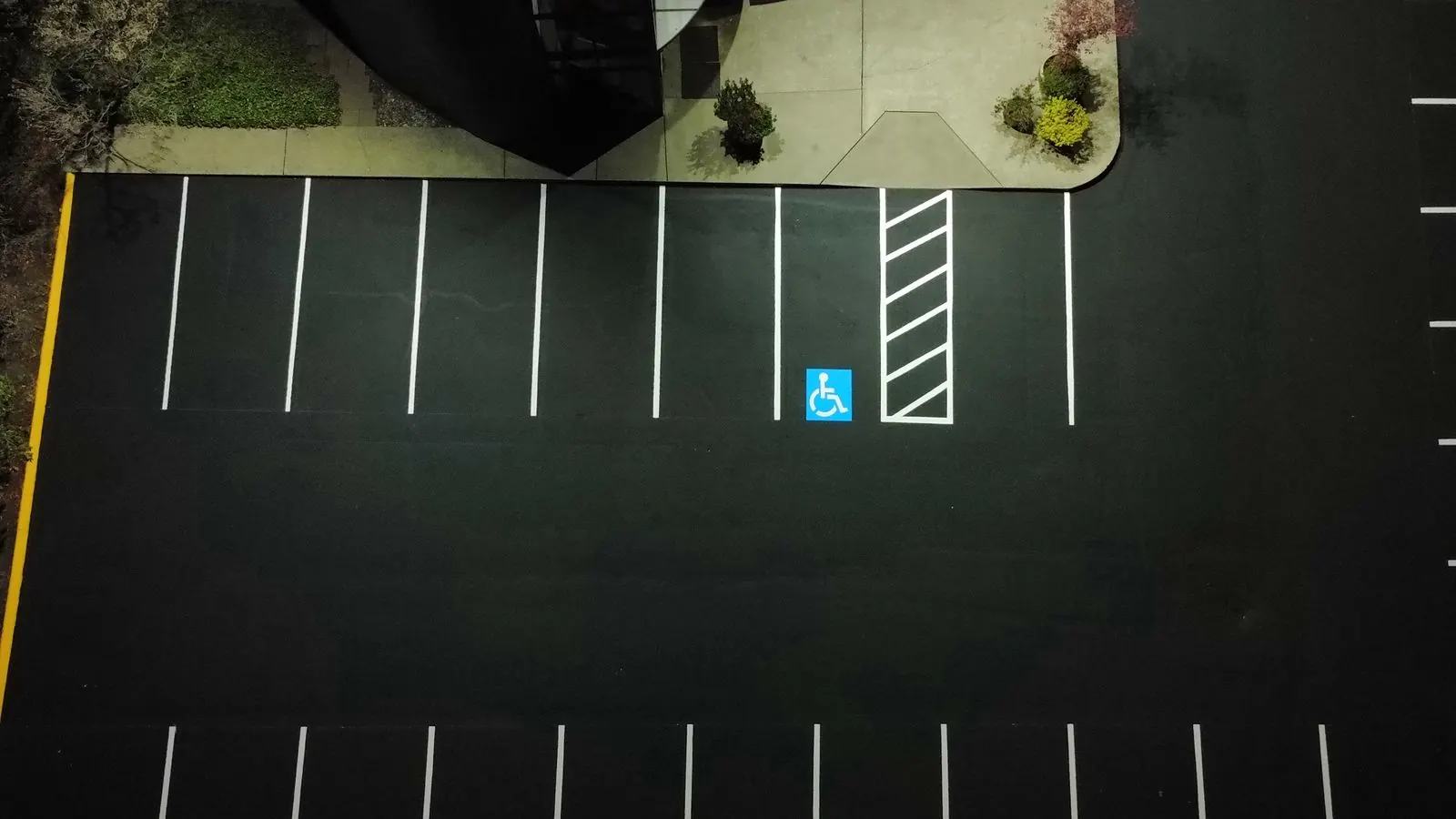 Parking lot after sealcoating and fresh striping — the maintenance outcome