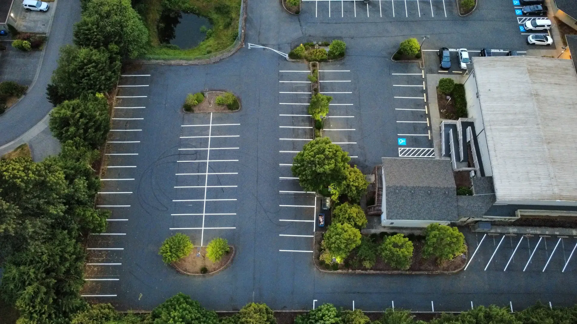Auburn church parking lot with fresh white striping around landscaped islands
