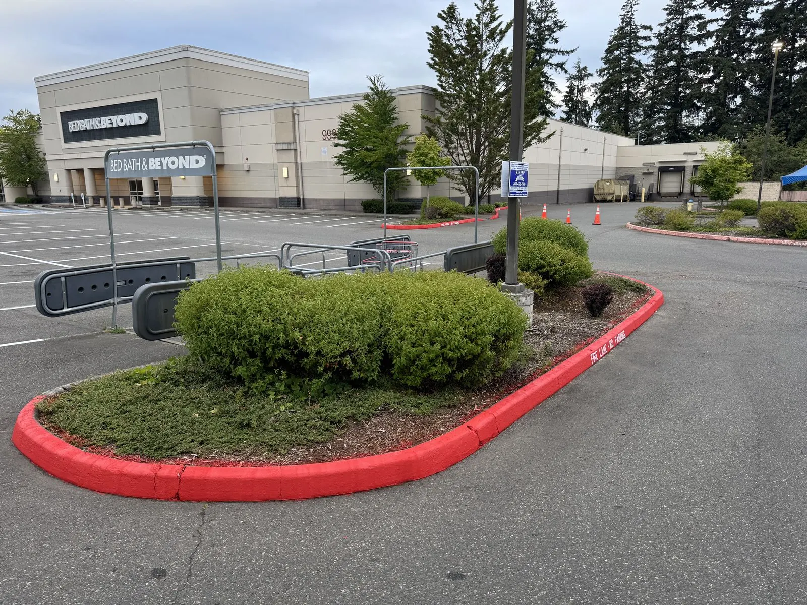 Red painted fire lane curb around a landscaped island at a retail property