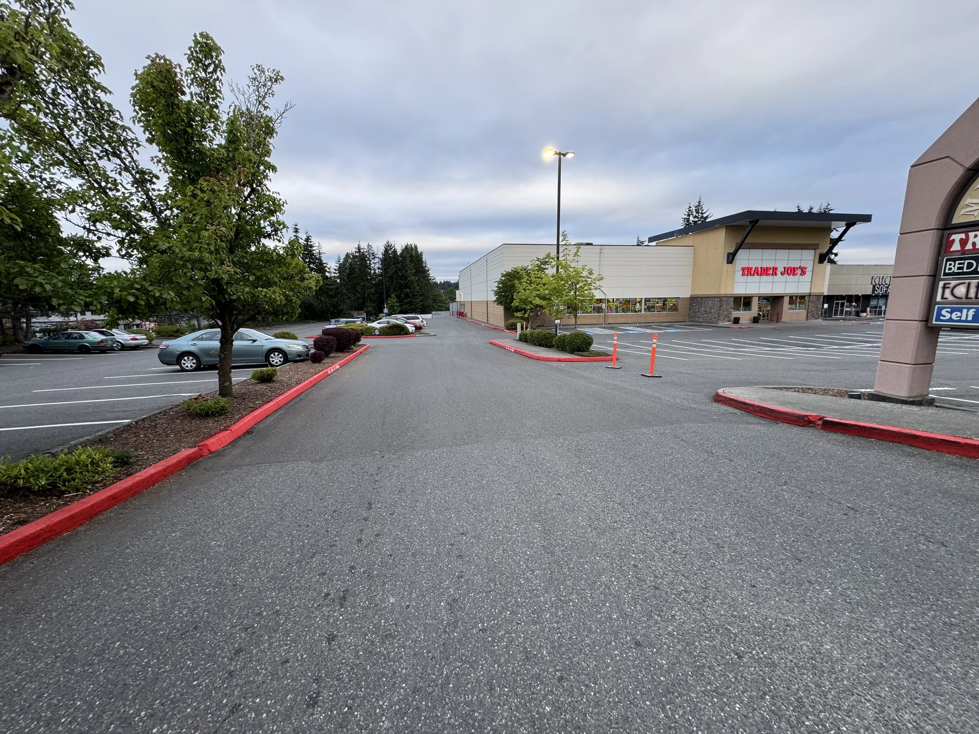 Freshly painted red fire lane curbs lining retail plaza drive lanes