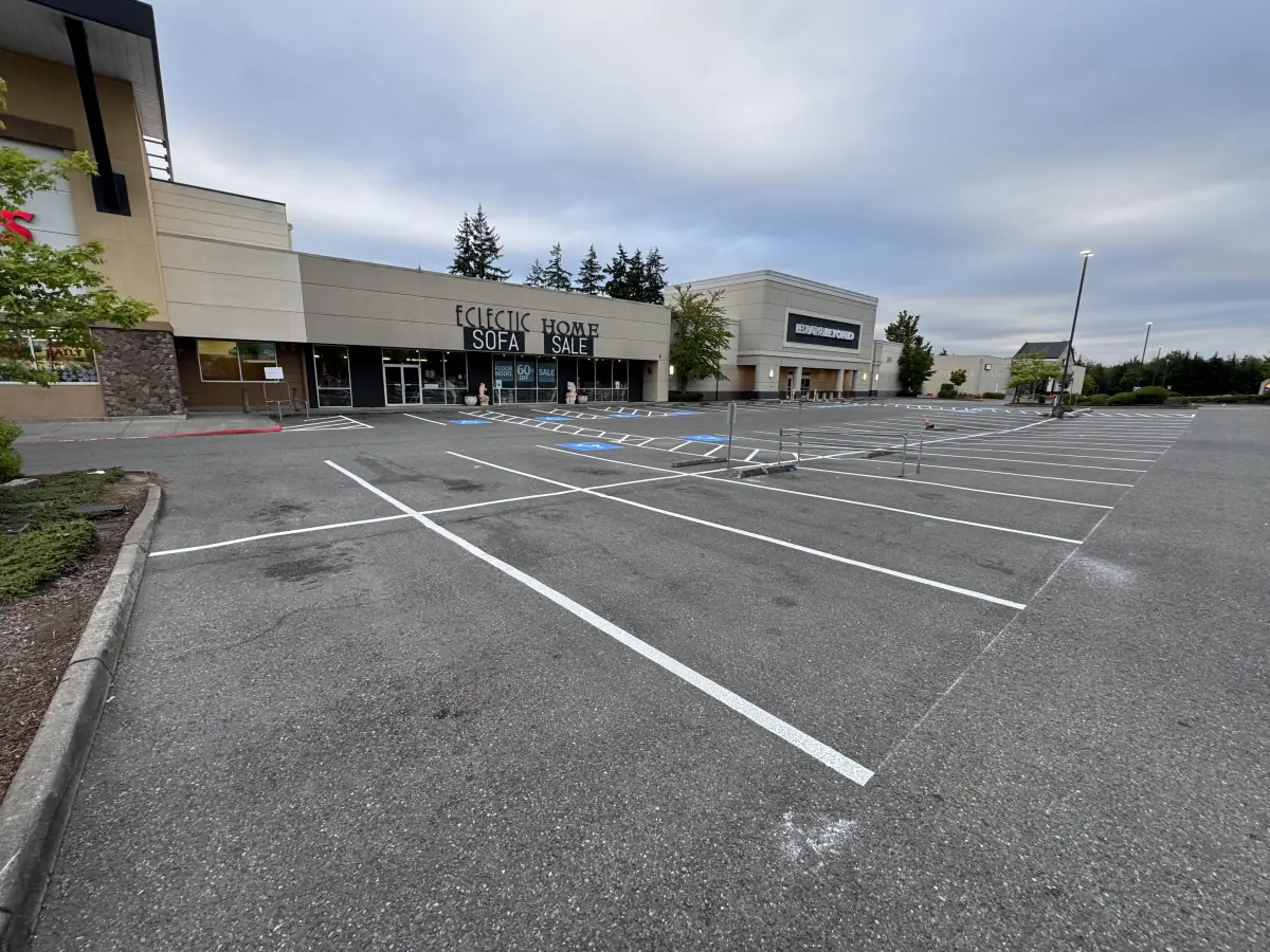 Retail center parking lot with brand-new white striping and ADA stalls