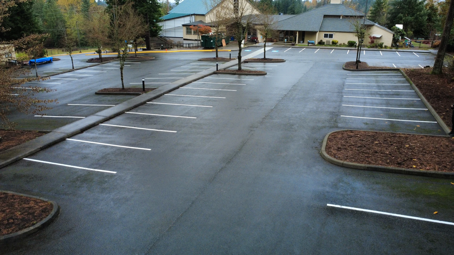 Wide view of a freshly striped church parking lot in Maple Valley